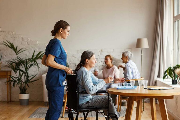 Older adults participating in a seated exercise class in a bright, accessible activity room.